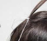 Isolate a lock of Hair at the back of the head just behind the crown. Tie with string approximately 1 centimeter from the root. 